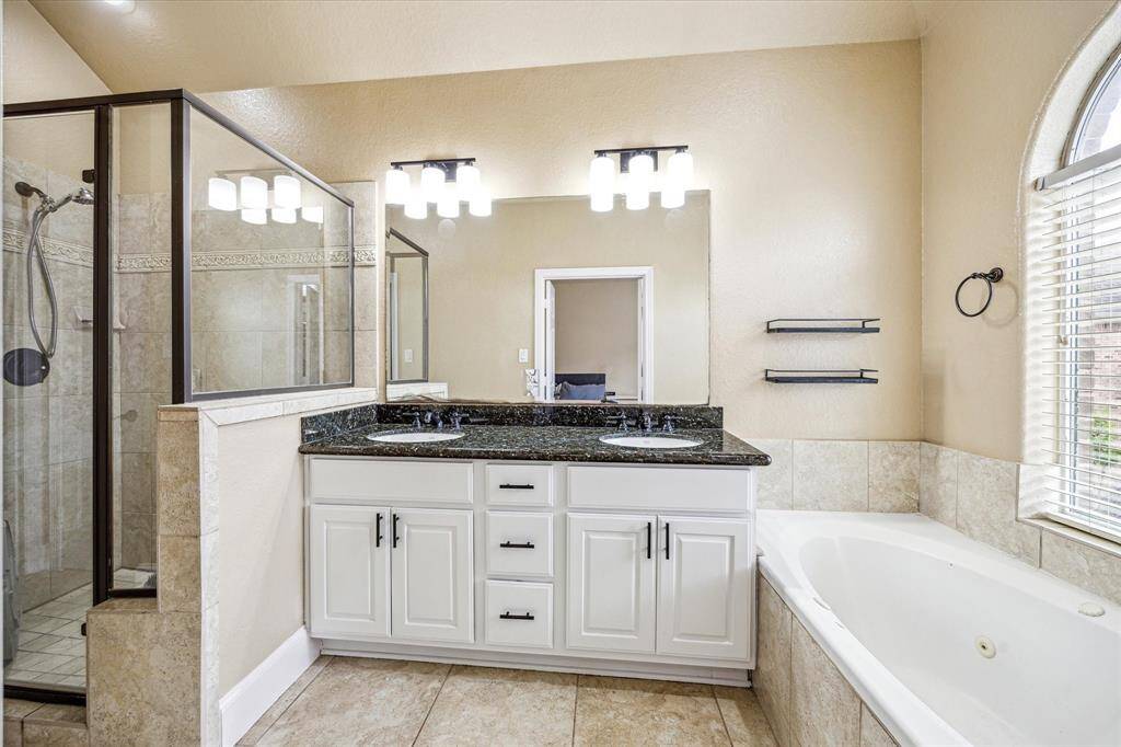 Primary bath with separate shower and jetted tub. Double sink vanity.