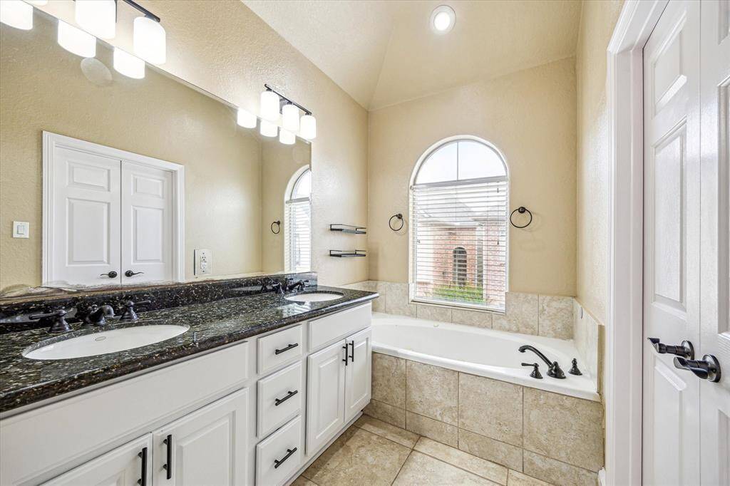 View of primary bath toward tub and window allowing natural light.