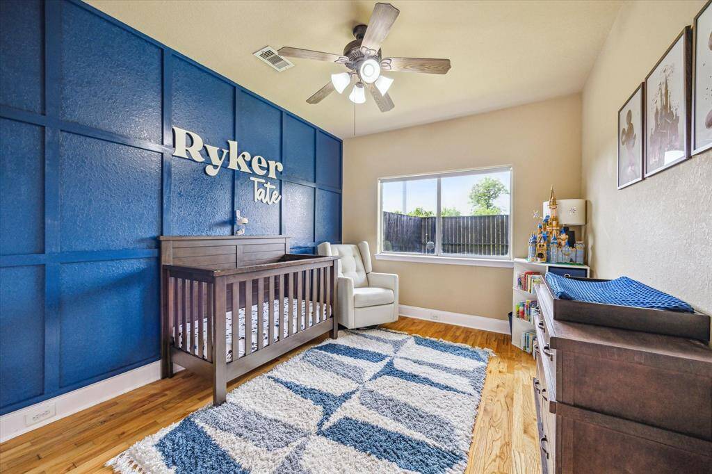 1st of two secondary bedrooms on lower level with view to backyard.