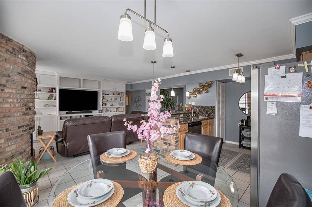 This inviting dining area sits at the heart of the condo, seamlessly connecting the family room and kitchen for effortless entertaining and everyday living.