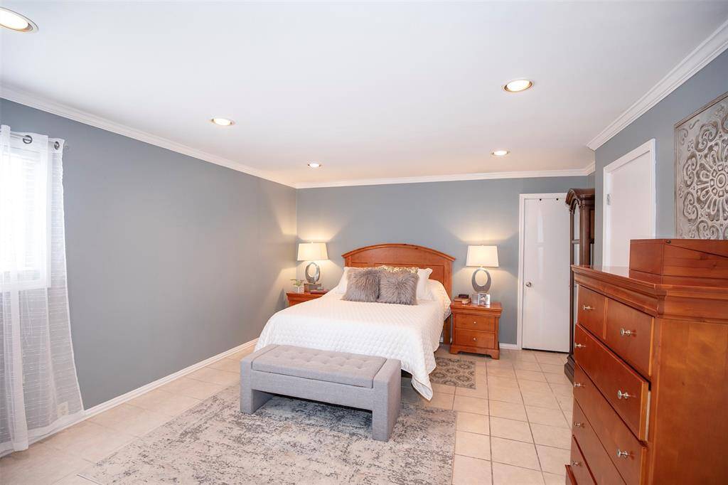 This comfortable bedroom in the condo offers a private and functional retreat, complete with its own bathroom and a conveniently located utility room.