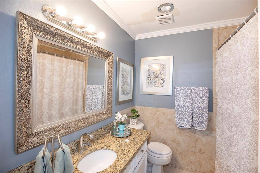 The en-suite bathroom provides added privacy and ease, featuring modern fixtures and a clean design.
