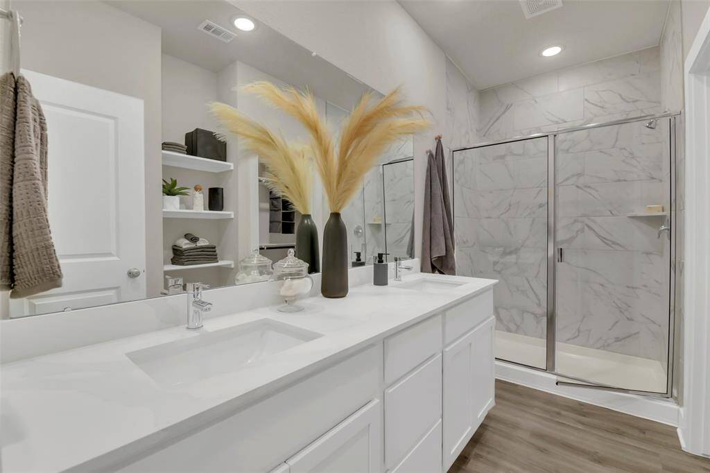 Primary bathroom with walk in shower and double sinks
