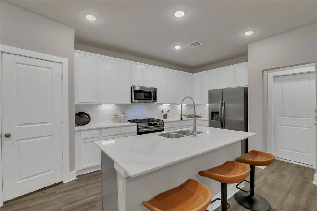 Kitchen with Island and double sink. Great breakfast area, large pantry, and a convection oven.