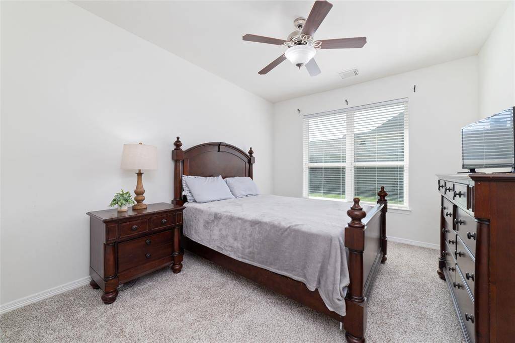 The third secondary bedroom features a new carpeted, fresh neutral paint, and ceiling fan. Located in the back corner of the house off the breakfast area with access to a full bathroom that can also be used for guests.