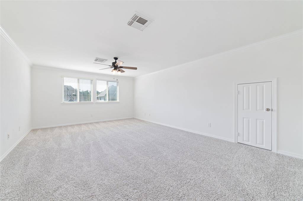 Upstairs is a large game room with fresh carpet, new ceiling fan, fresh neutral paint, and lots of natural light.  There is also storage for games and toys.