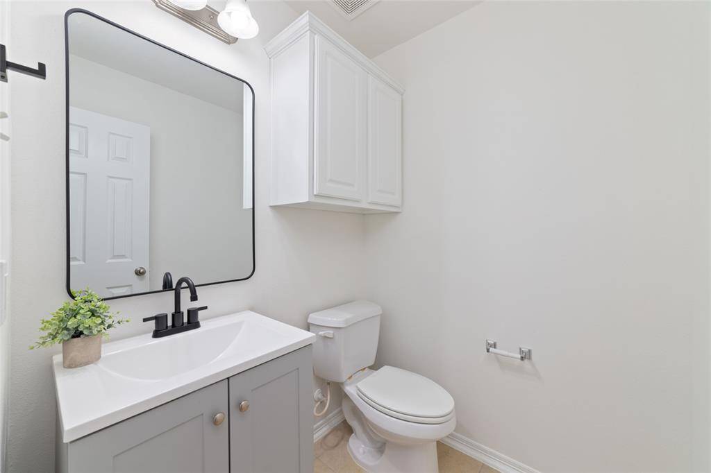 Upstairs is also a spacious half bath for guests to use. New vanity and mirror finish out the space.