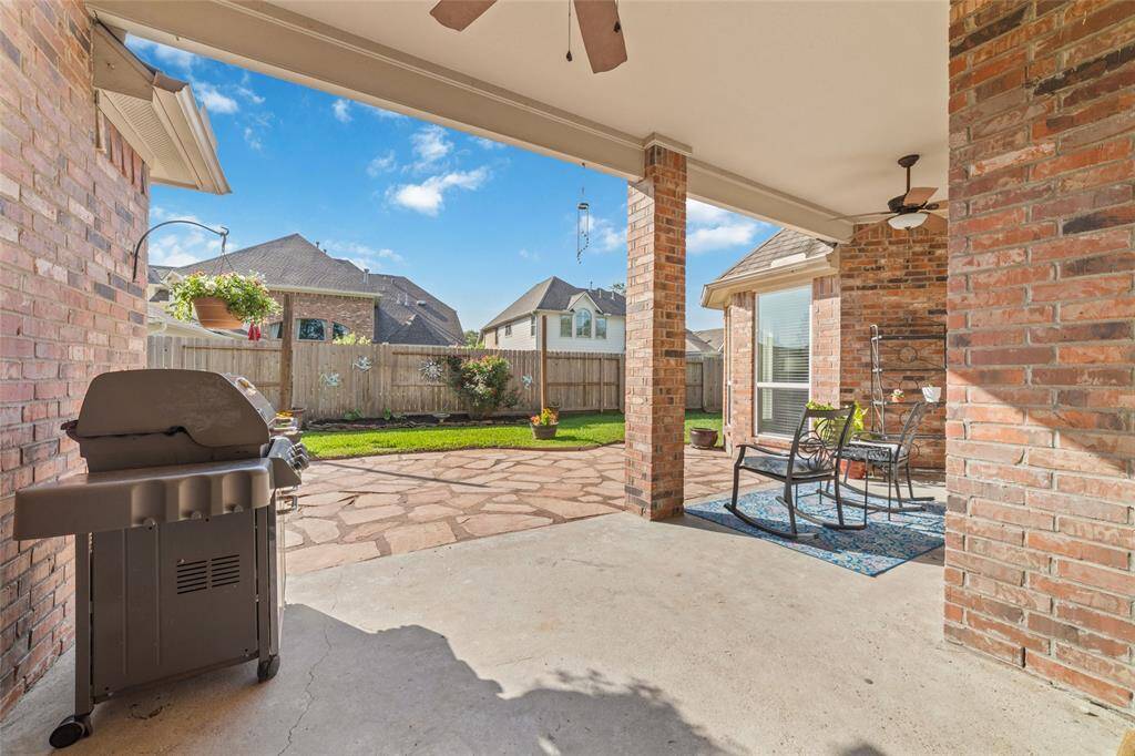 Large covered patio opens up to the backyard.