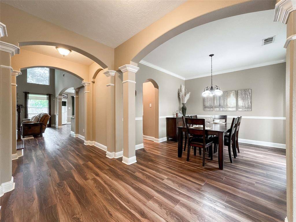 Across from the office is the formal dining area with stylish lighting, decorative chair railthat leads into the kitchen for easy access for hosting.