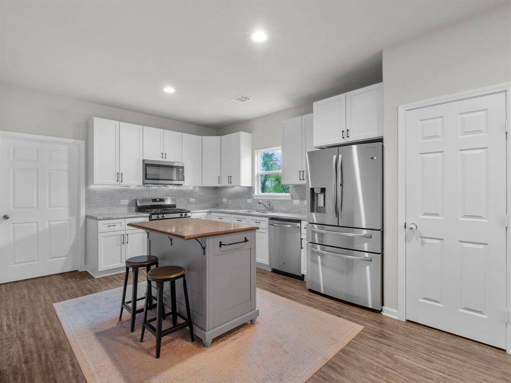 Stainless steel appliances round out the kitchen (Refrigerator can stay)