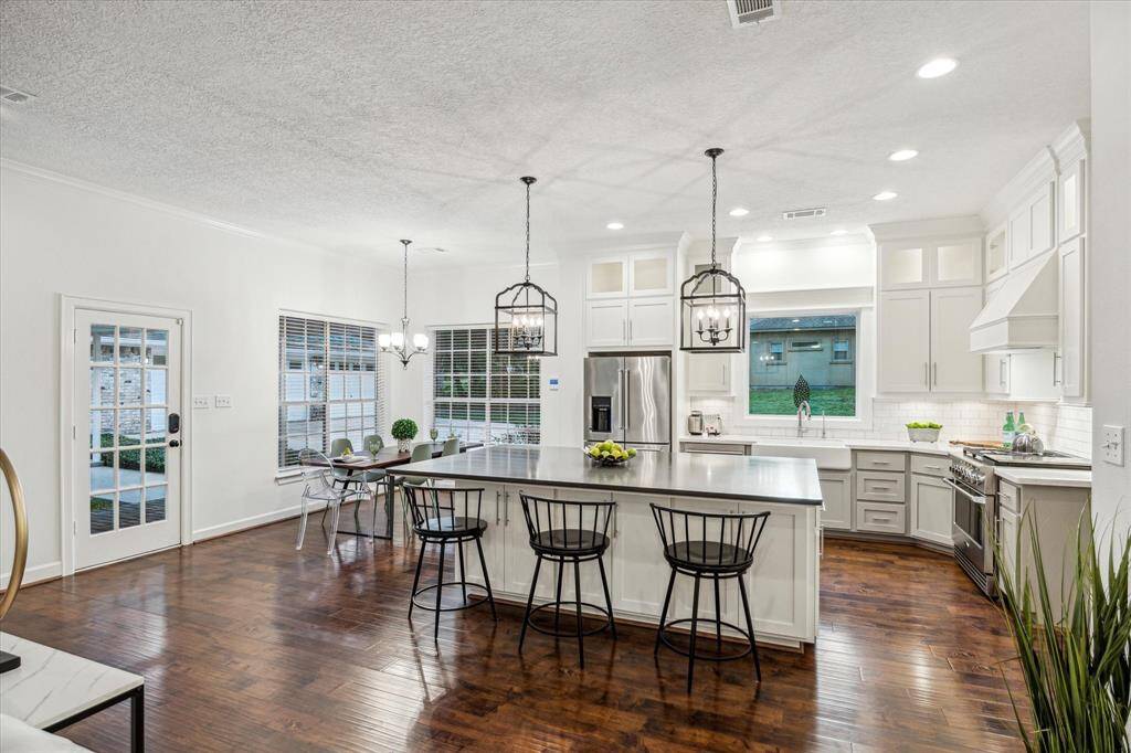 Kitchen and living room open to the peaceful backyard.