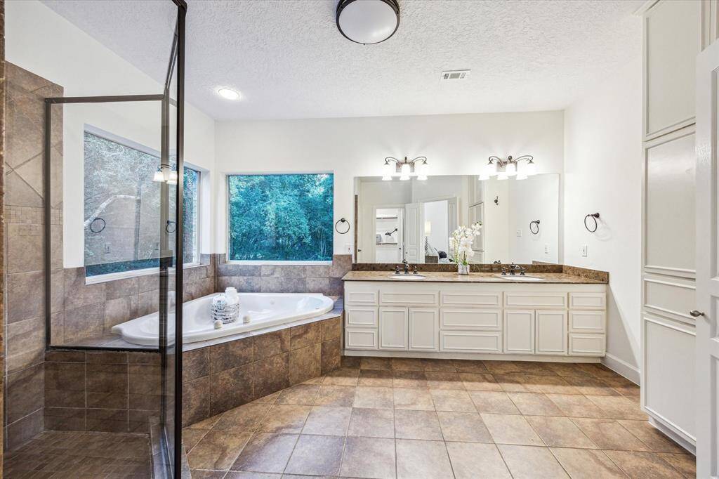 Primary bath off bedroom with separate shower, tub and double sinks.