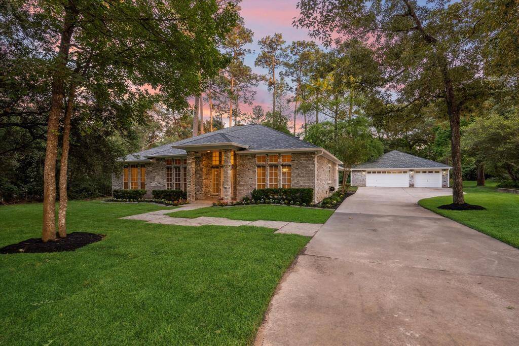 Front of Home showing driveway and three car garage.