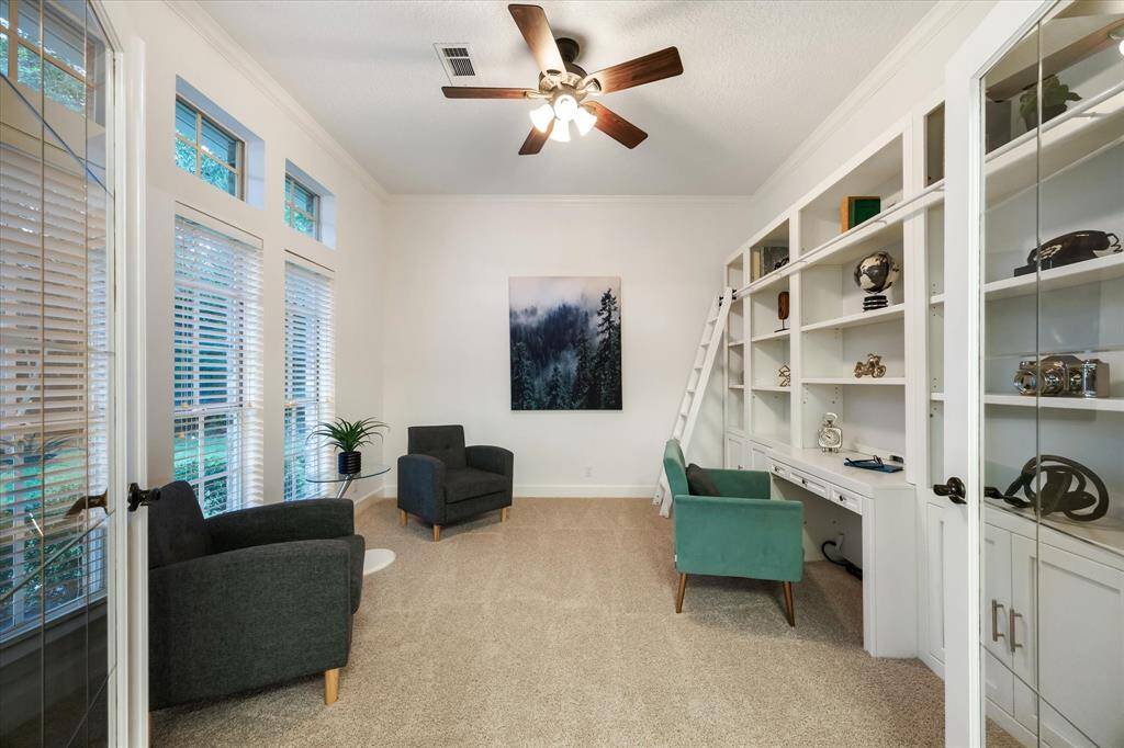 Private study with French doors and built-in shelving.