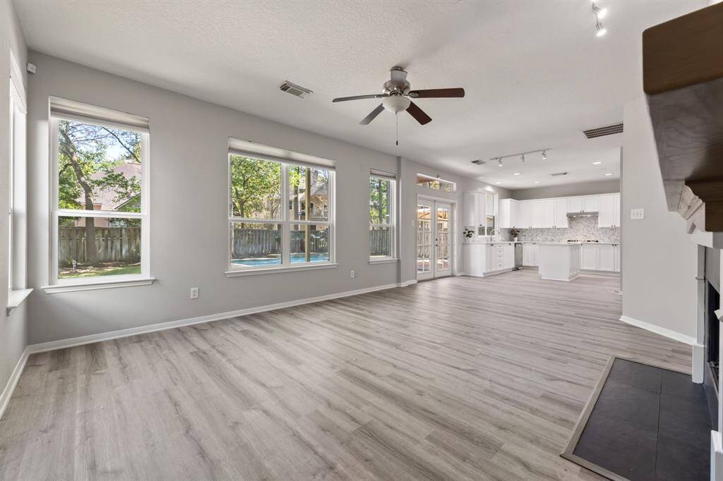 The room flows seamlessly into a bright, contemporary kitchen .