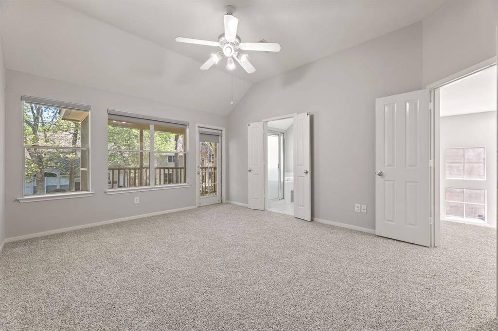 This Primary bedroom also  includes an en-suite bathroom and access to a balcony, offering a comfortable and airy living space.