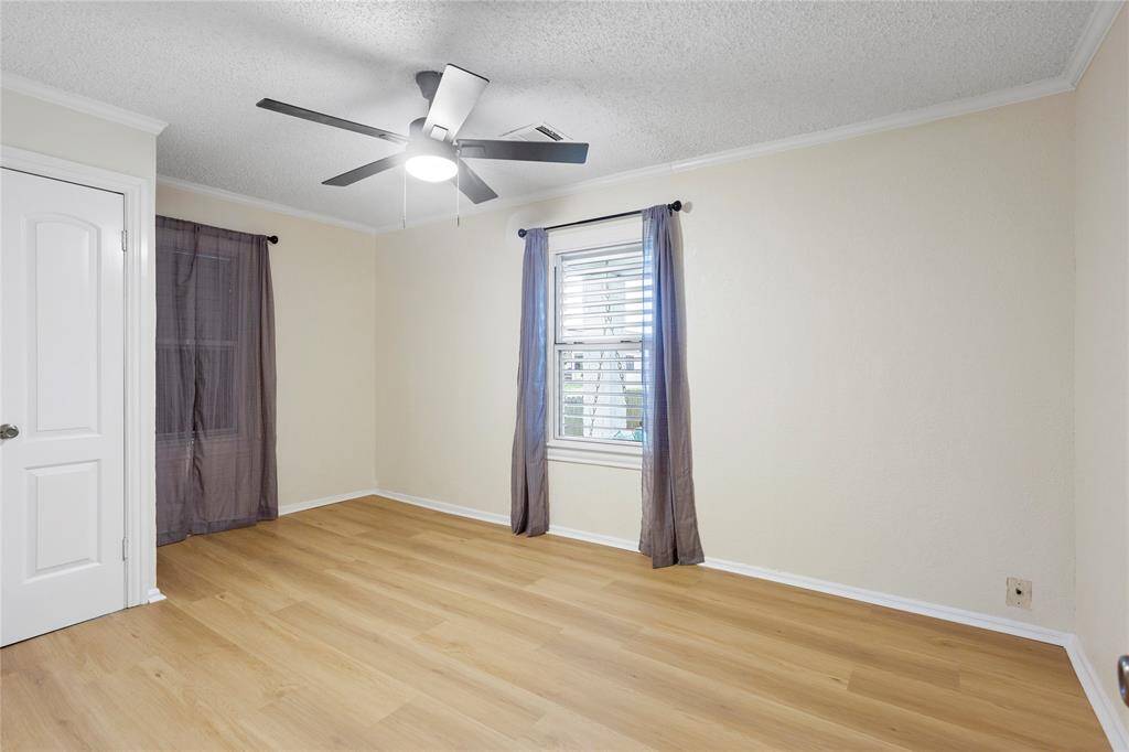 Bedroom 1 new LVP floors, fan light, window treatments