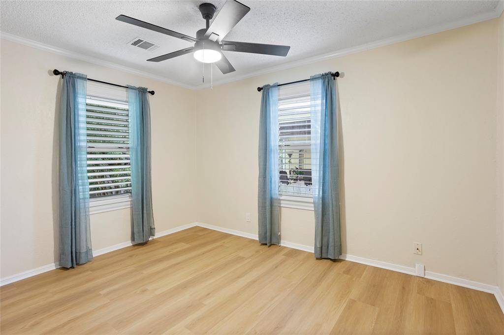 bedroom 2. New LVP floors, window treatments and fan light
