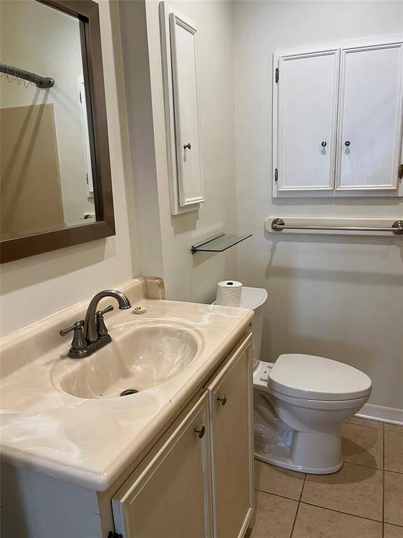 The bathroom has a generous-sized countertop, and lots of storage cabinets.