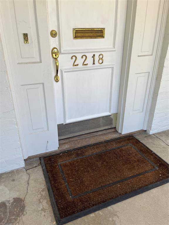 The entry has beautiful trm, to complement the Craftsman architecture. Brass hardware accents the door,