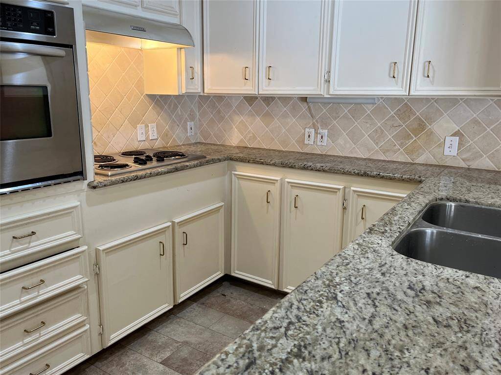 When you enter the kitchen, this is your view to your left. Beautiful granite countertops, under counter lighting, and so much storage,