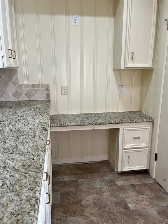 Across the wide countertop, there are lower cabinets for more storage and a convenient work station.