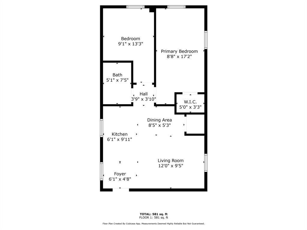 Charming blue triplex with a welcoming front porch, fenced yard, and a driveway. Surrounded by trees, it offers a cozy and inviting atmosphere.