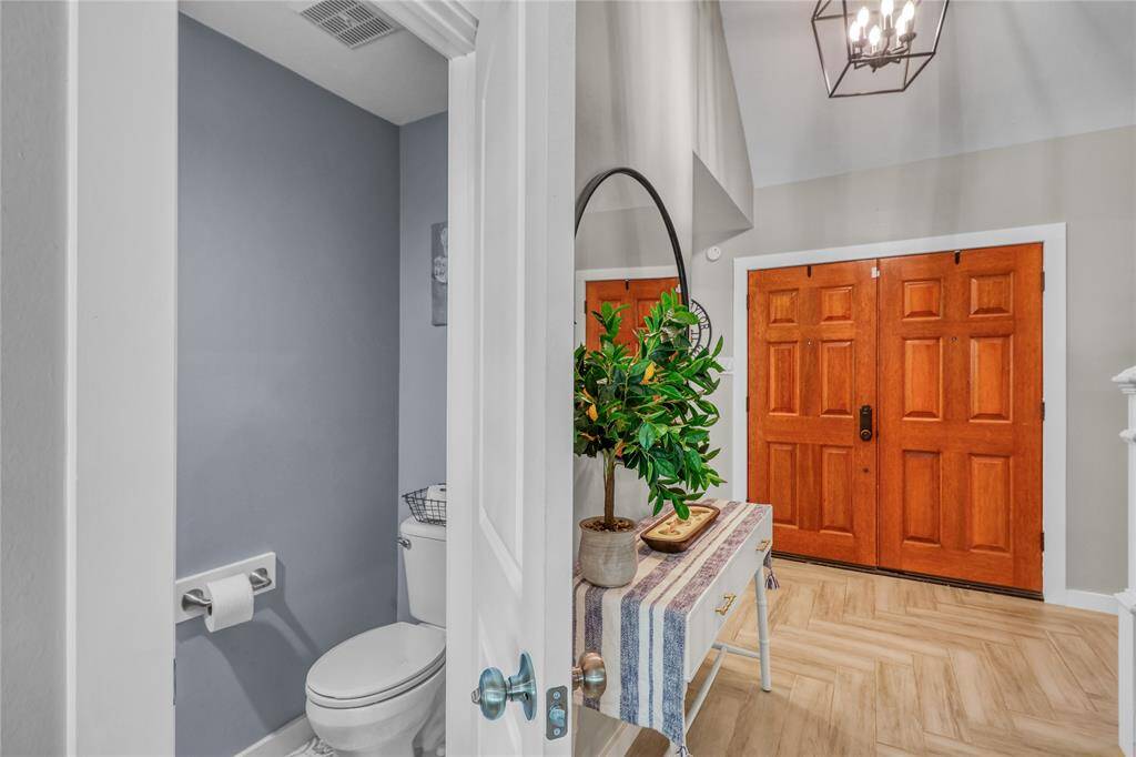 The powder room is tucked back behind the Foyer.