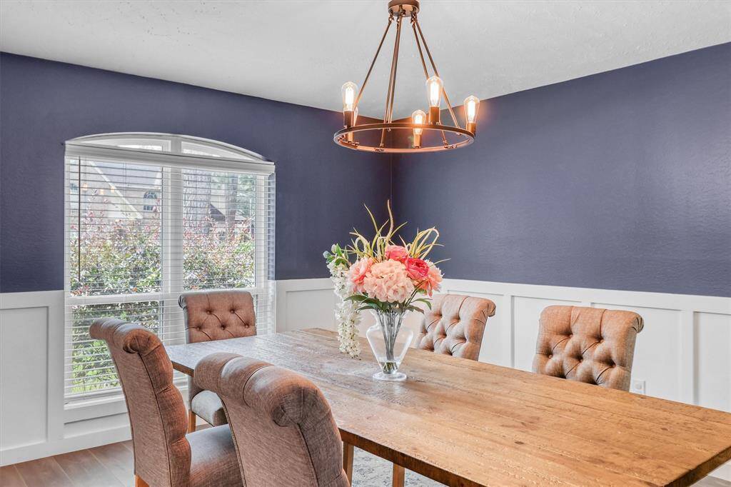 Lovely Formal Dining Room with updated light fixture, wainscotting & designer blue paint.