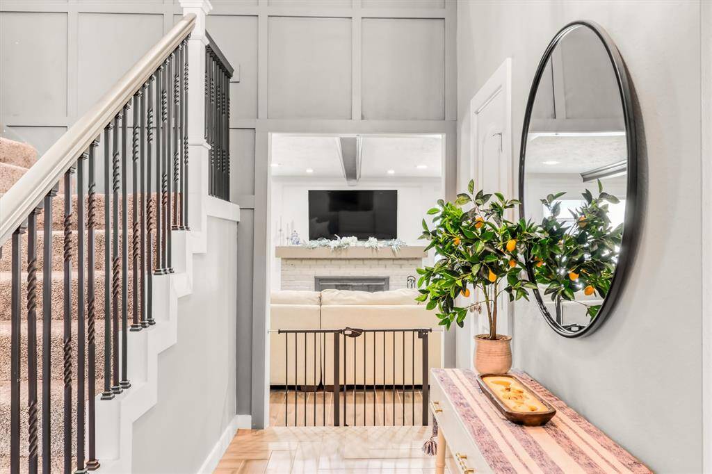Wrought Iron rails, paneled walls and high ceilings in the Foyer.