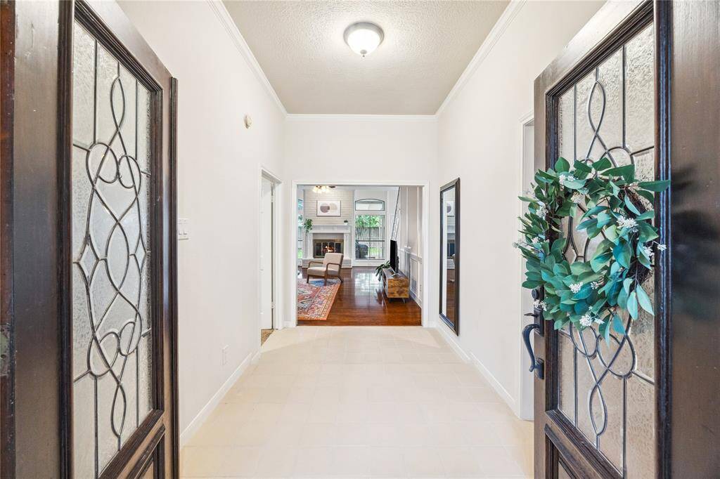You can’t miss the beautiful craftsmanship of this room - elegant floors, custom built-ins, fresh paint - anchored by a cozy brick fireplace perfect for gatherings.
