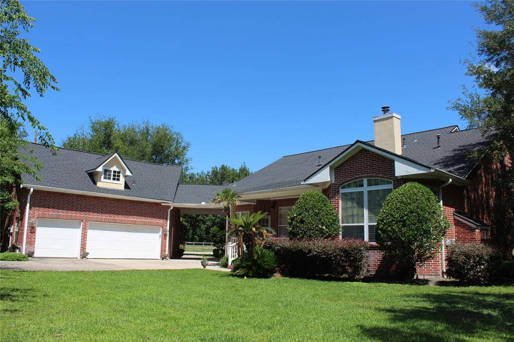 View of backyard and garages