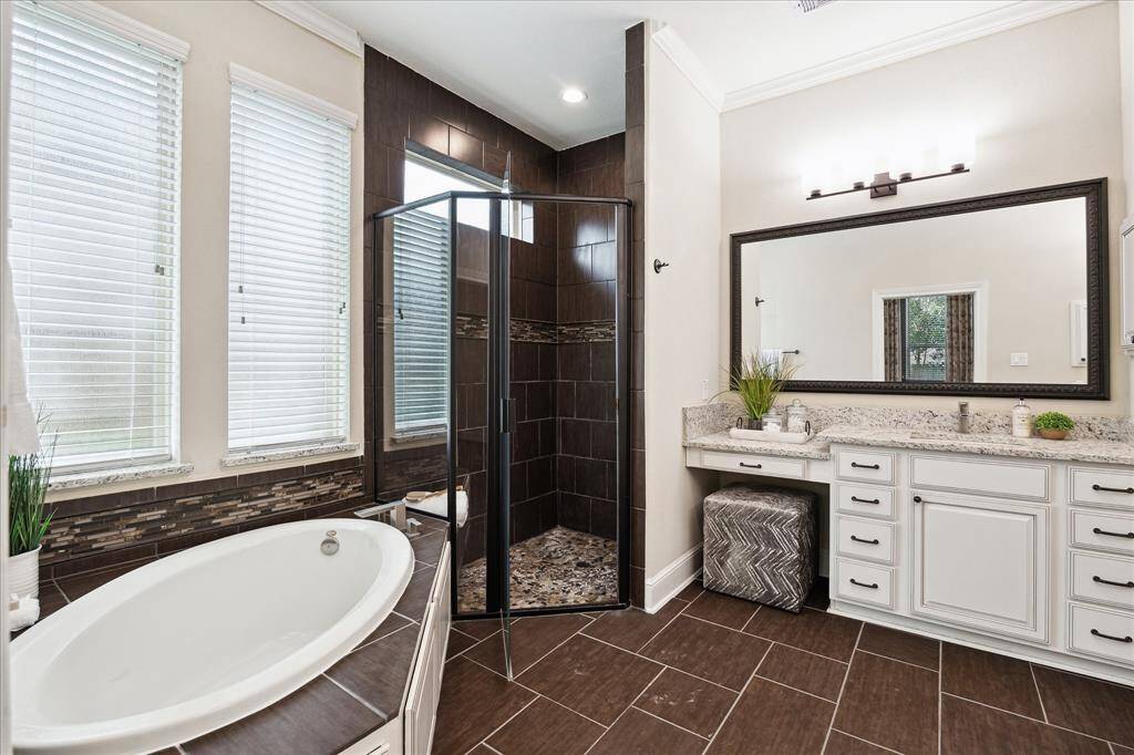 Primary bath contains soaker tup, large shower and two separate sink areas.