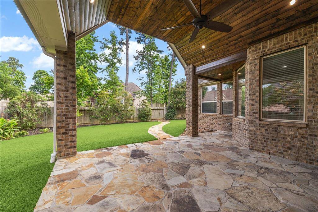Beautiful stone covered patio, with elegant plank ceiling.