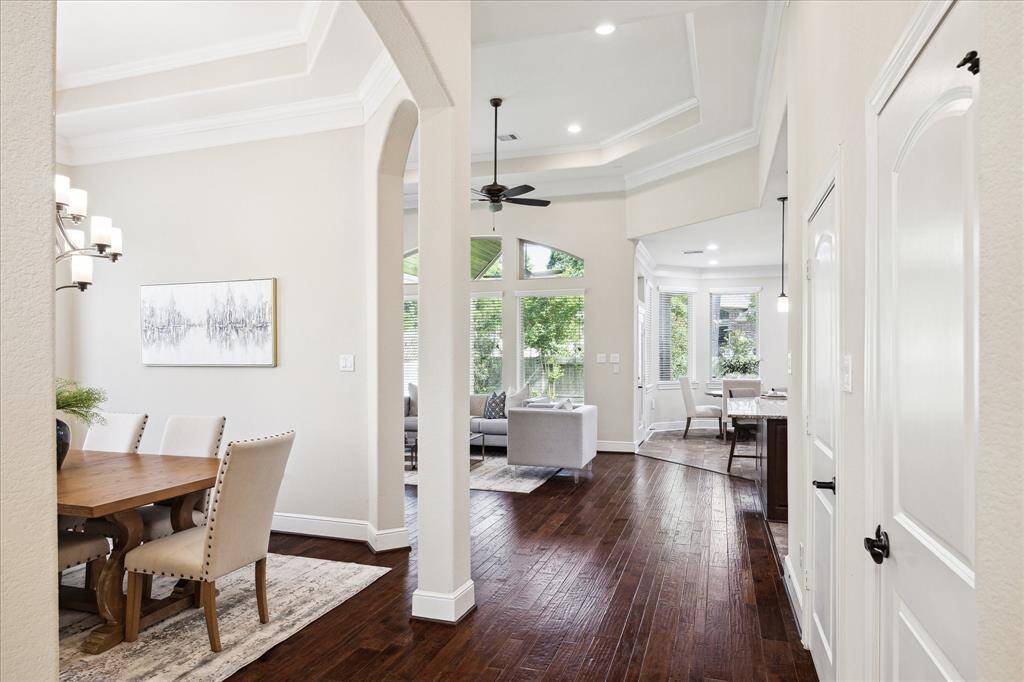 View from the entry looking toward the living space and kitchen (to the right in the picture).  Numerous windows allow great natural light to flow into the room and enjoyment of the landscaped backyard.