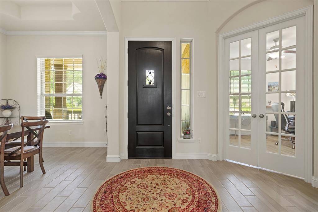 Welcome home! Step inside to find a charming dining room on the left and a spacious office on the right.
