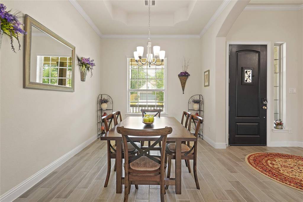 Elegant tray ceilings enhance the charm of this spacious front dining room.