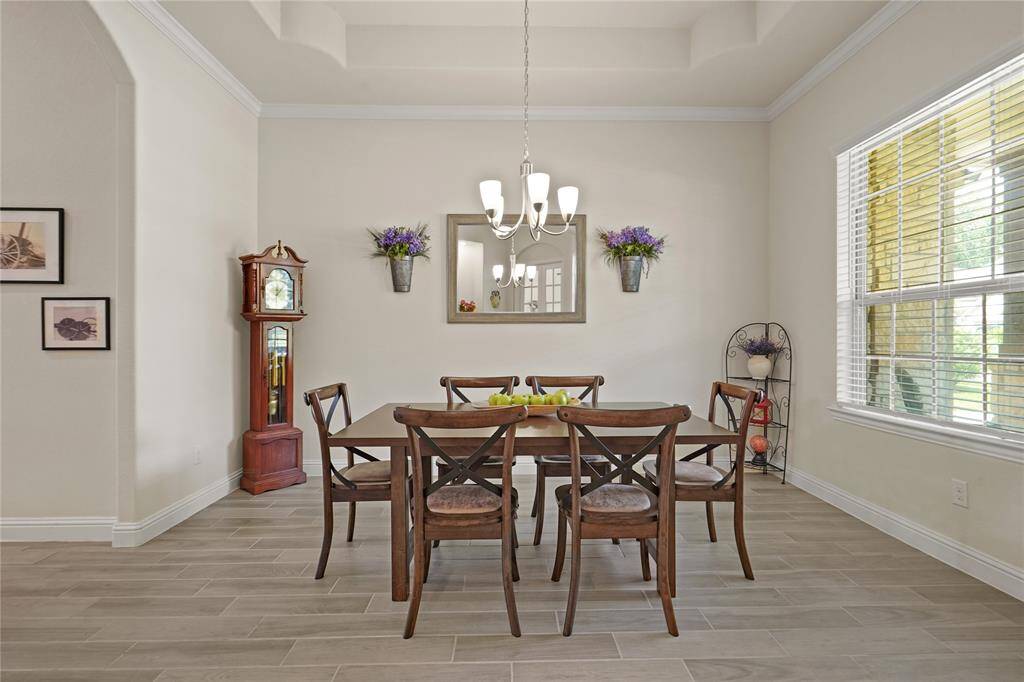 Bright formal dining area with stunning wood-look tile flooring.