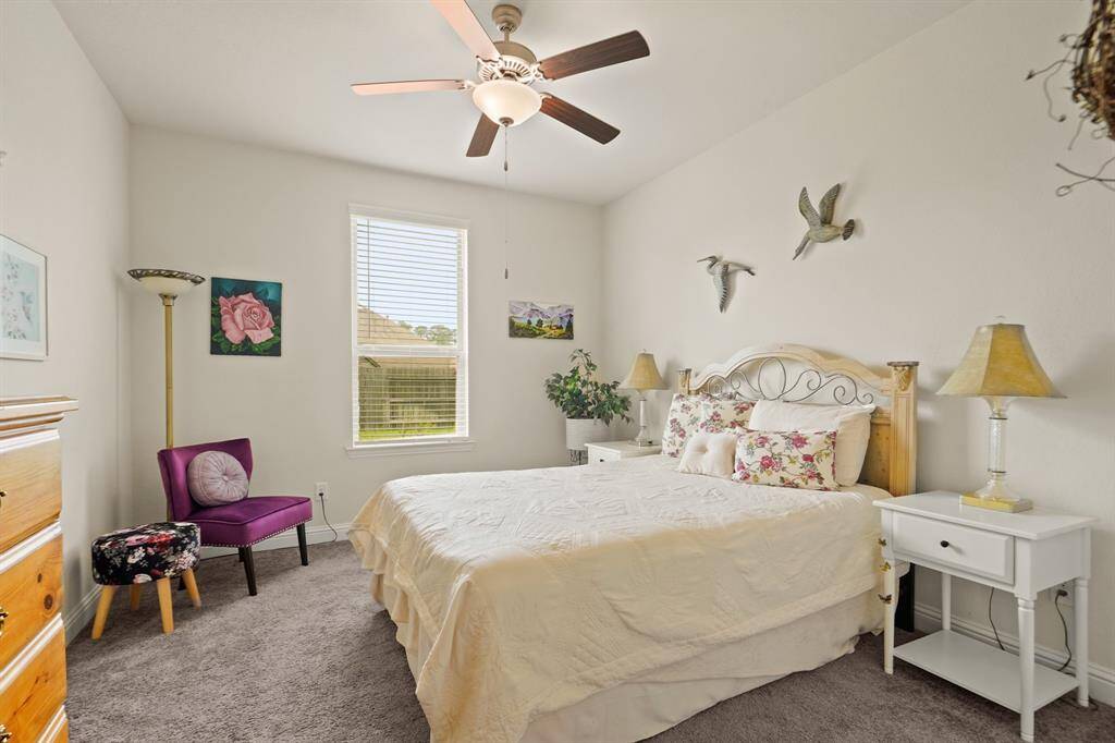 This spacious first-floor bedroom, tucked away in its own private hallway, offers the perfect potential for a second suite.