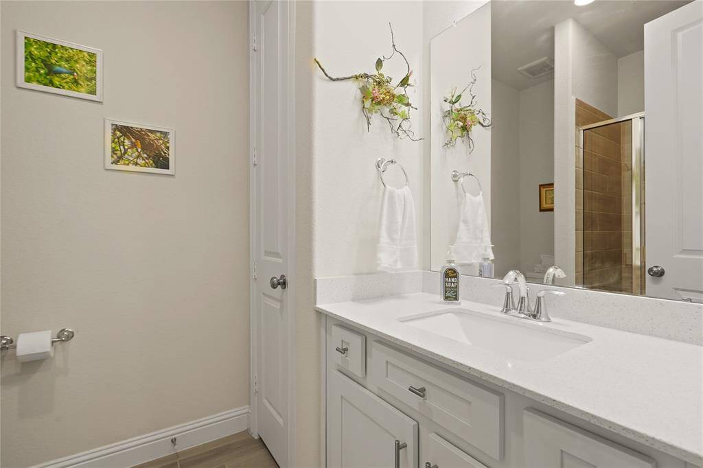 This hallway bathroom features a walk-in shower and can easily be transformed into a private mother-in-law suite.