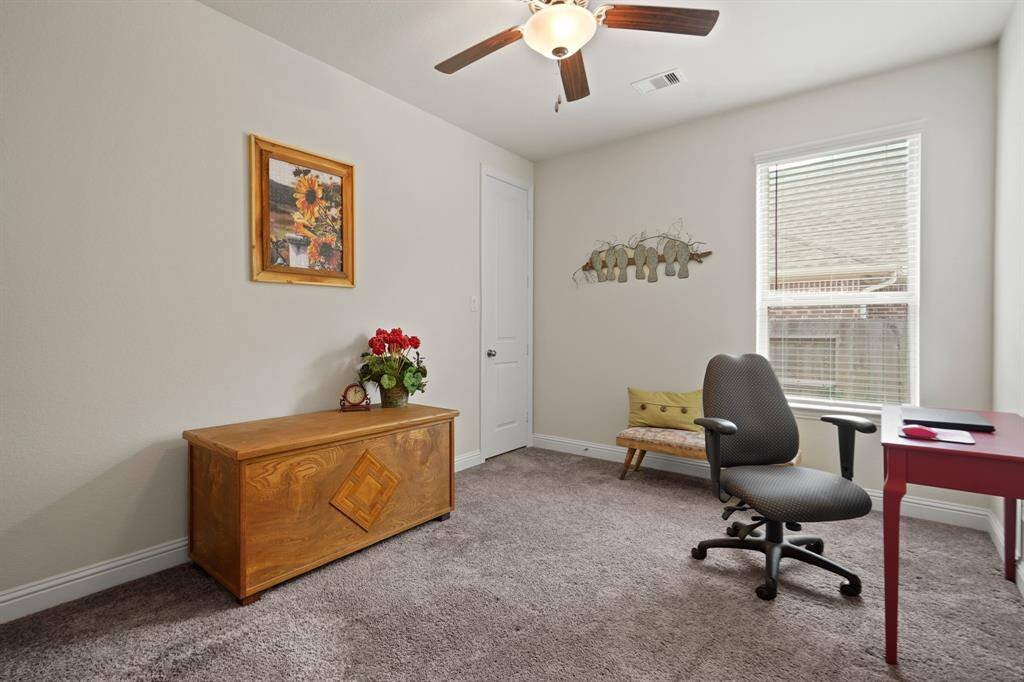 This versatile secondary bedroom is currently set up as a second office, offering flexible space for work or relaxation.