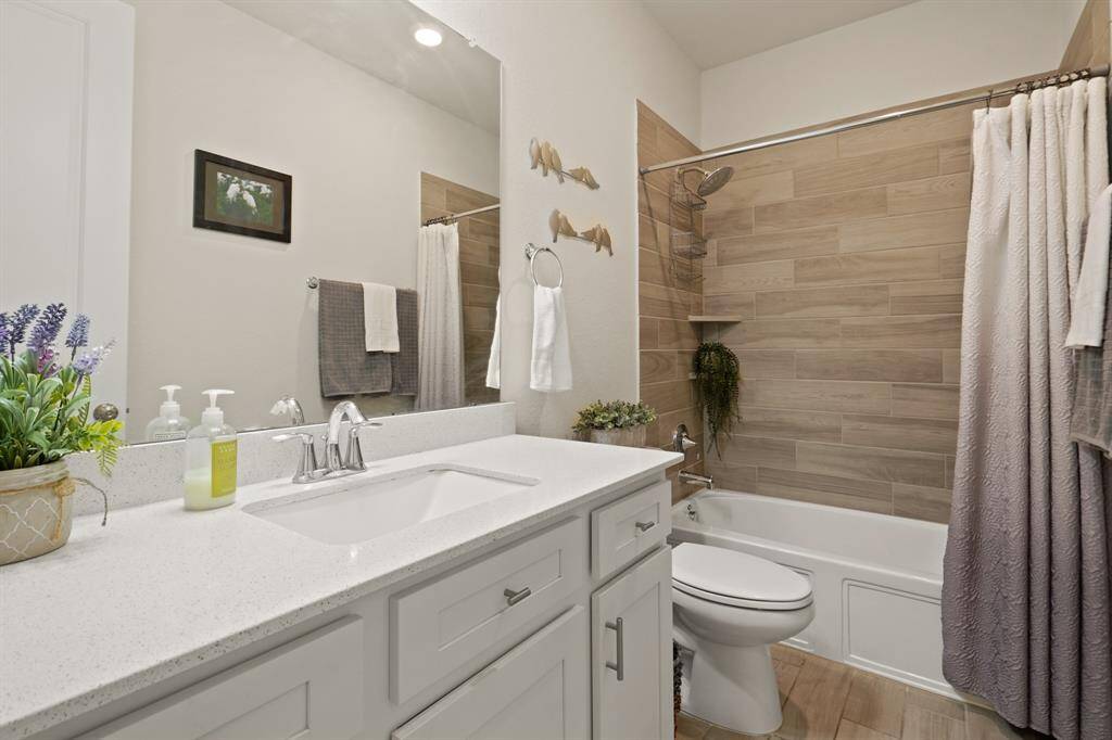 This elegant full bath conveniently serves two bedrooms, offering style and functionality.