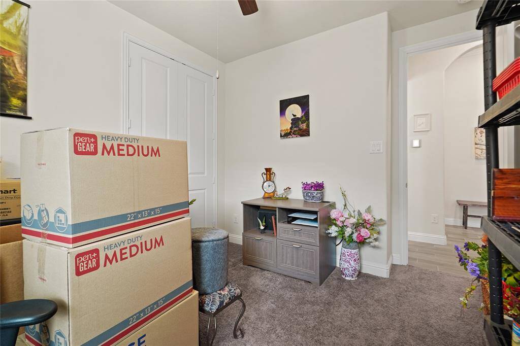 This cozy secondary bedroom features convenient access to a shared bath, just beyond the back wall.