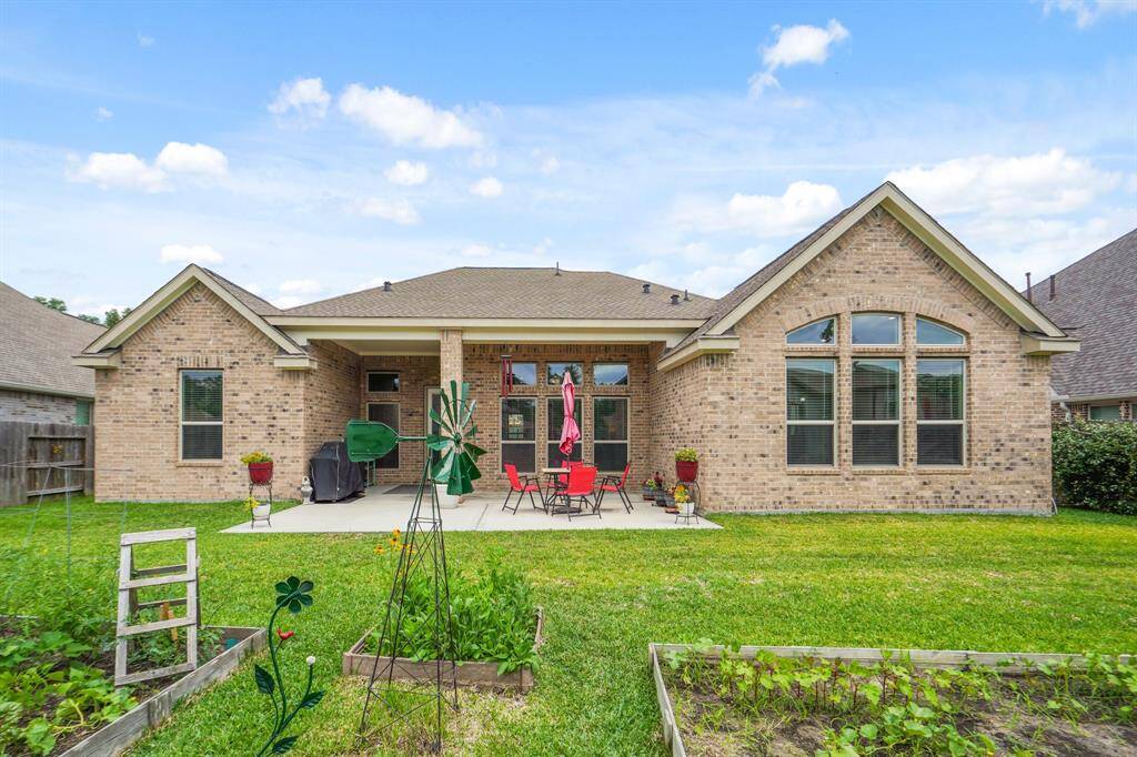 Charming brick exterior with a bright, window-filled design and a spacious backyard perfect for relaxation and entertaining.