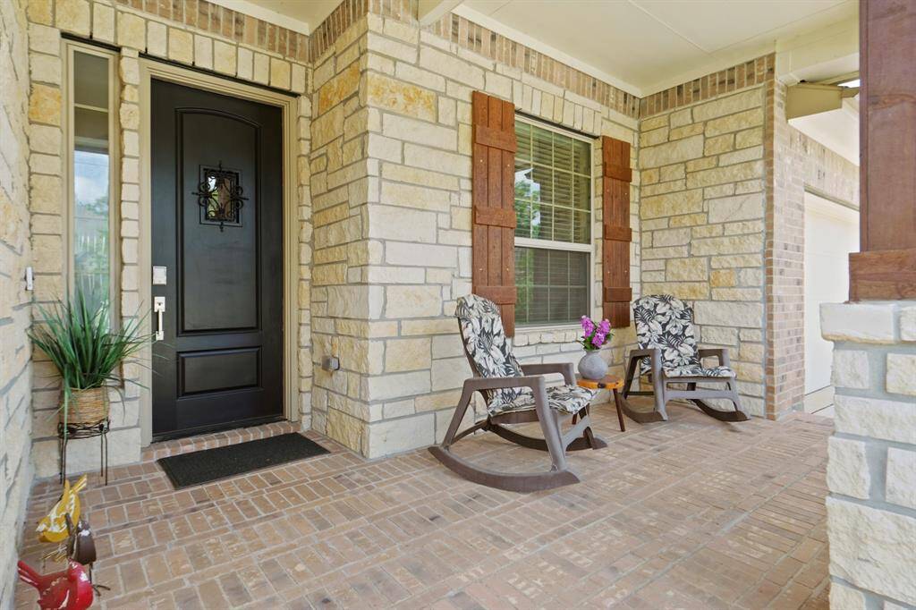 This spacious covered porch is perfect for relaxing outdoors.