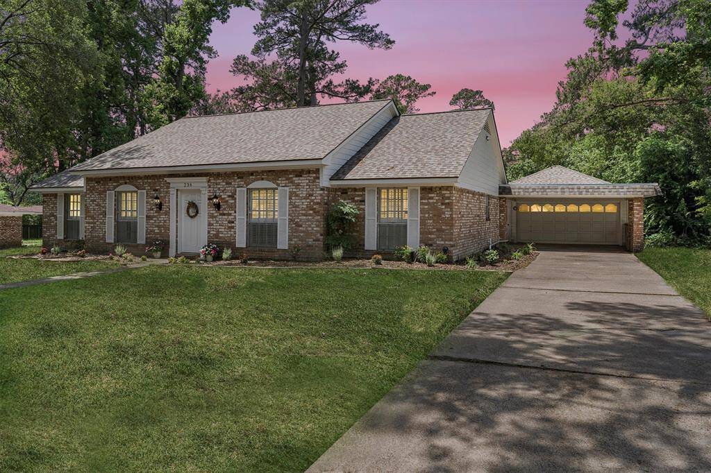 This charming home features a long driveway with attached 2 car garage