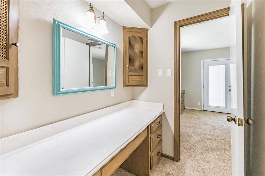 A private vanity area connected to bedroom 4, separated from the bathroom by a door