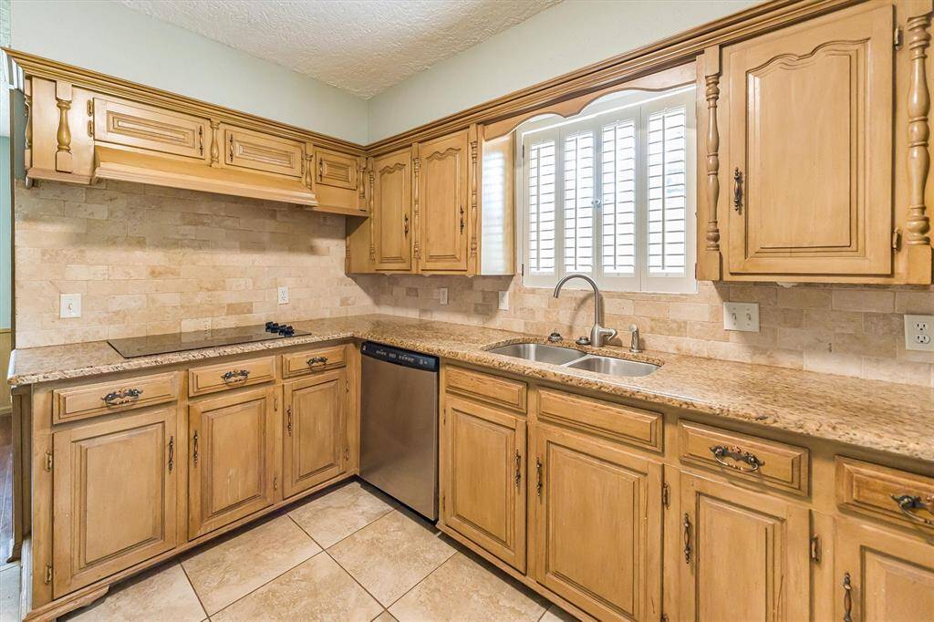 Includes dishwasher, double basin sink and window with plantation shutters