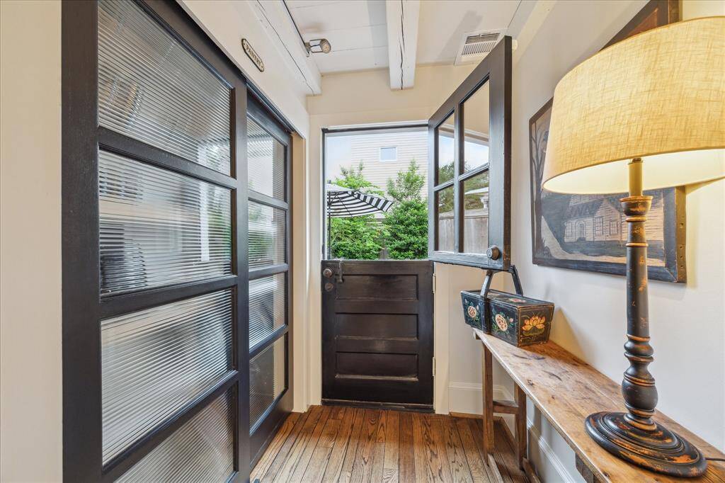 Kitchen backdoor hallway with pantry on the left side. The split door is open and reminds this family of "Mr. Ed's door"!