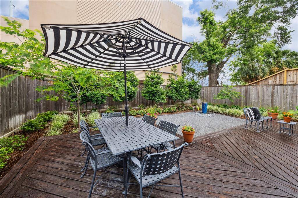 Expansive patio decking with room for a table and separate seating area. This is a beautful backyard.